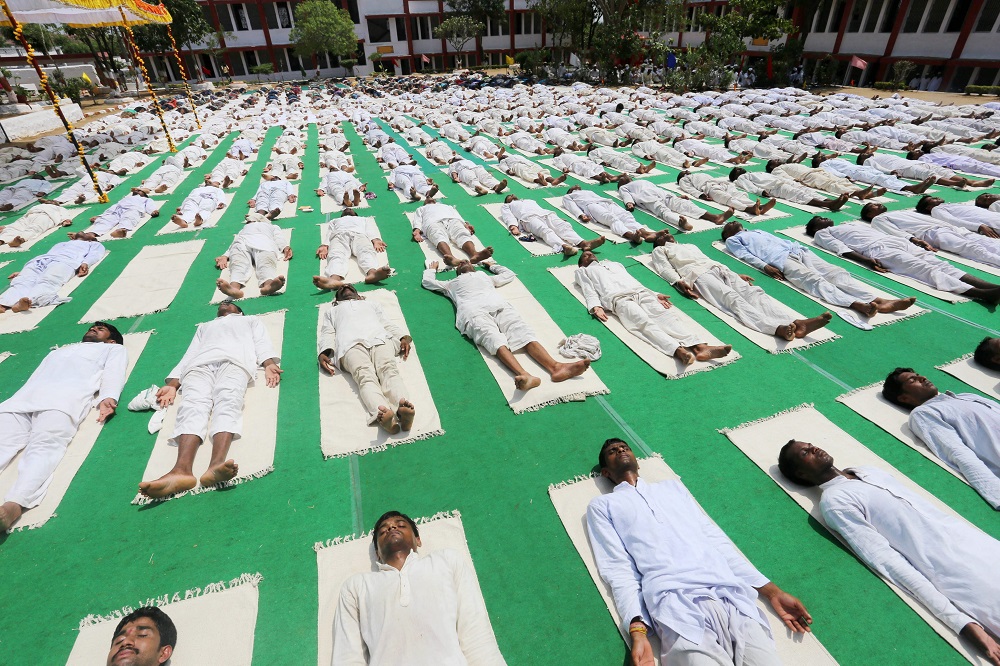 Inmates of Central Jail take part in a mass Yoga session on the occasion of first International Yoga Day in Bhopal.